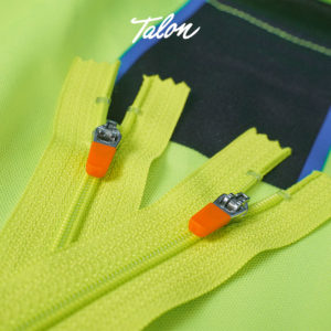 Neon green zipper with orange pull. Custom zippers by Talon International. 